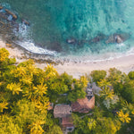 A house in front of a beautiful beach. Beach House fragrance oil by Scentivore.