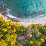 A house in front of a beautiful beach. Beach House fragrance oil by Scentivore.