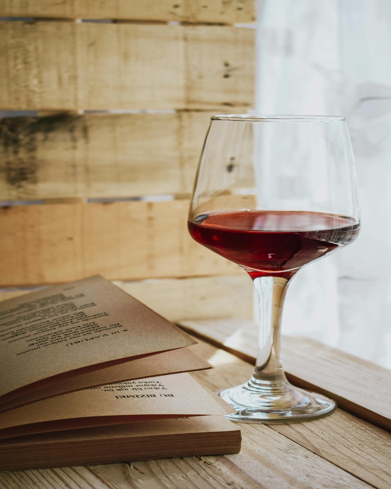 Black cherry merlot on a table with the book. Black Cherry Merlot fragrance oil by Scentivore.