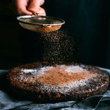 Chocolate lava cake being dusted with chocolate powder.  Chocolate Lava Cake fragrance oil by Scentivore.