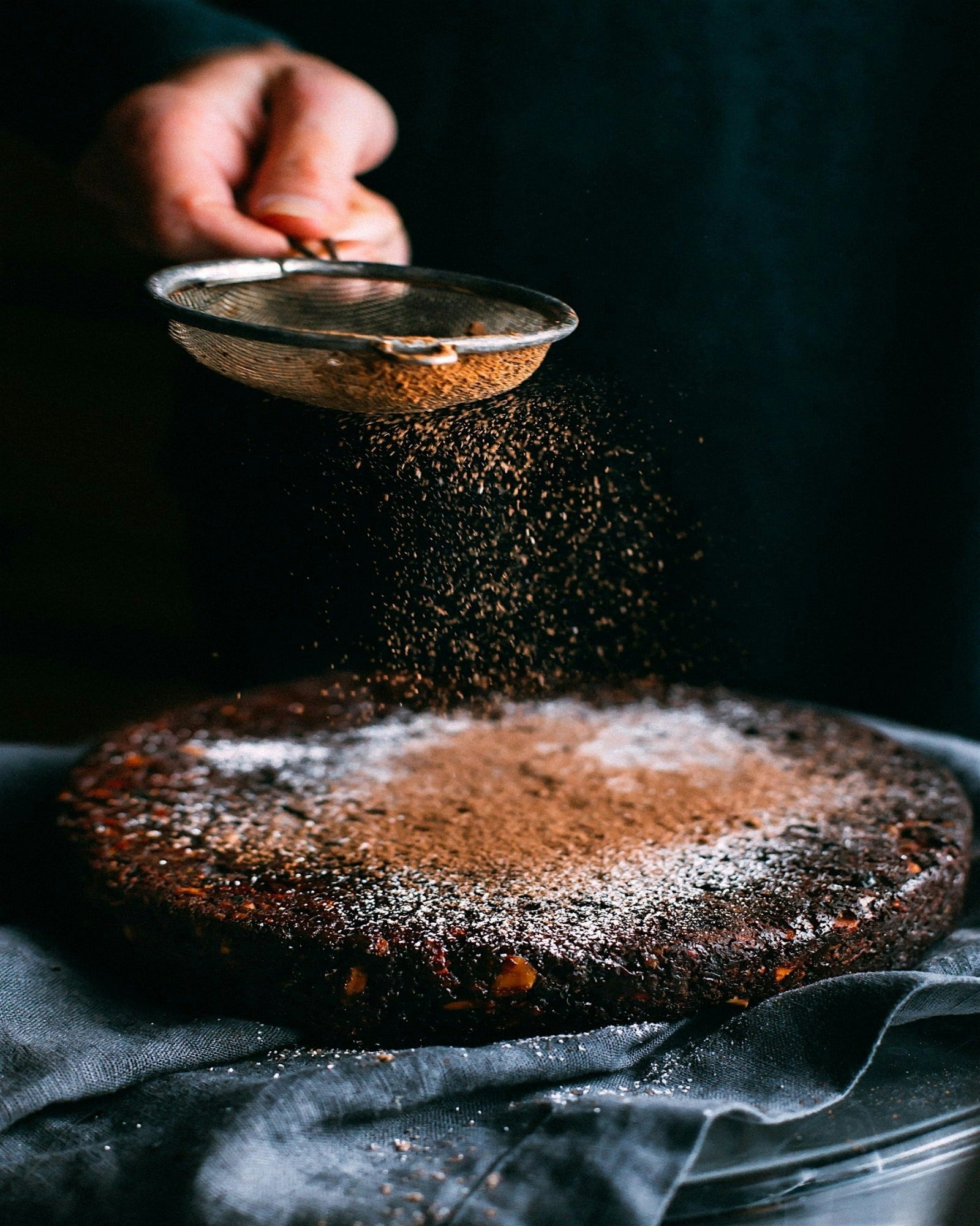 Chocolate lava cake being dusted with chocolate powder.  Chocolate Lava Cake fragrance oil by Scentivore.