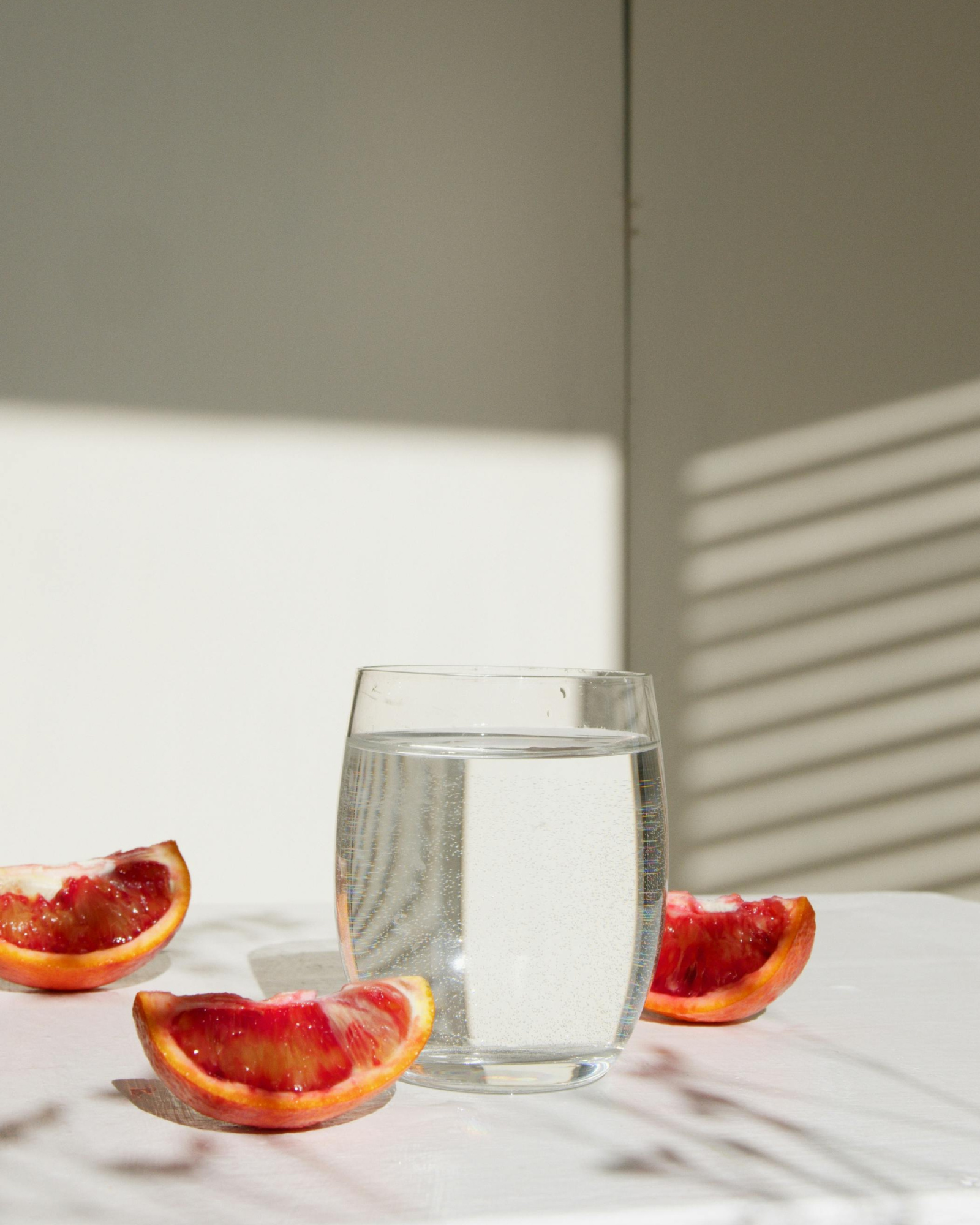 Citrus fruits and a glass of water. Daybreak Citrus Bloom fragrance oil by Scentivore.