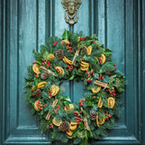 Holiday wreath on a door. Fresh Yuletide Wreath fragrance oil by Scentivore. 