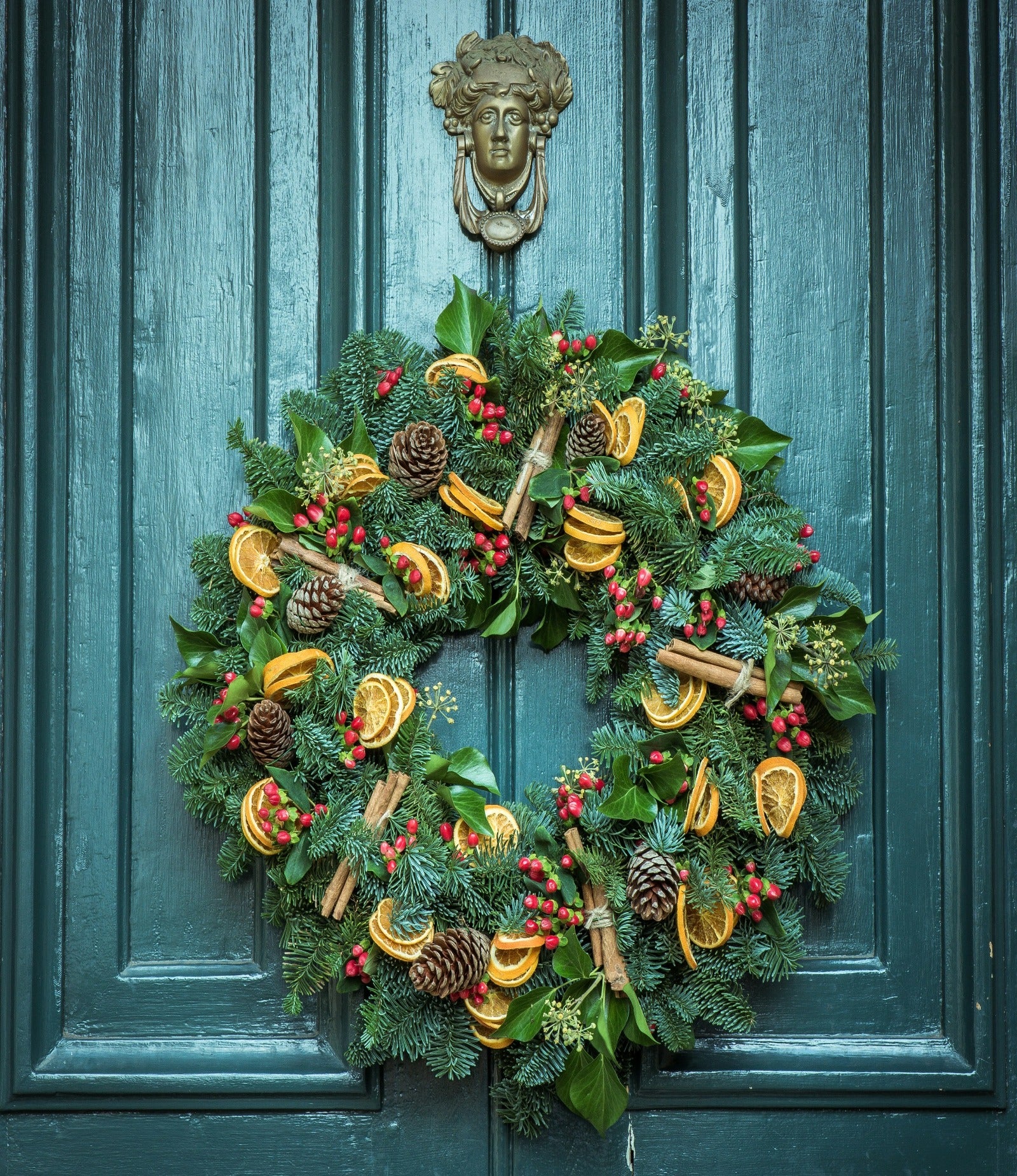 Holiday wreath on a door. Fresh Yuletide Wreath fragrance oil by Scentivore. 