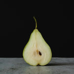 A sliced in half pear. Green Anjou Pear fragrance oil by Scentivore. 