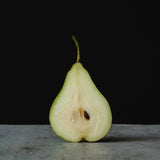 A sliced in half pear. Green Anjou Pear fragrance oil by Scentivore. 