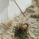 Umbrella and flower basket on the beach. Salt Beach fragrance oil by Scentivore. 