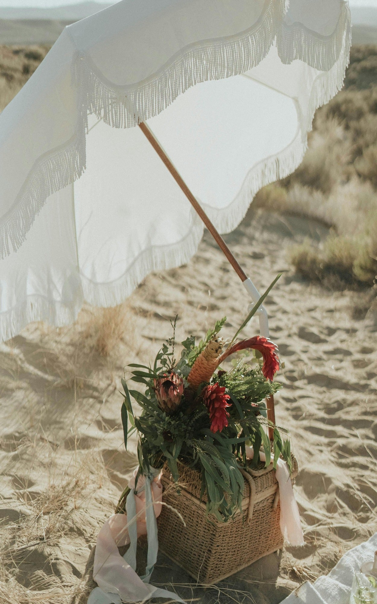 Umbrella and flower basket on the beach. Salt Beach fragrance oil by Scentivore. 