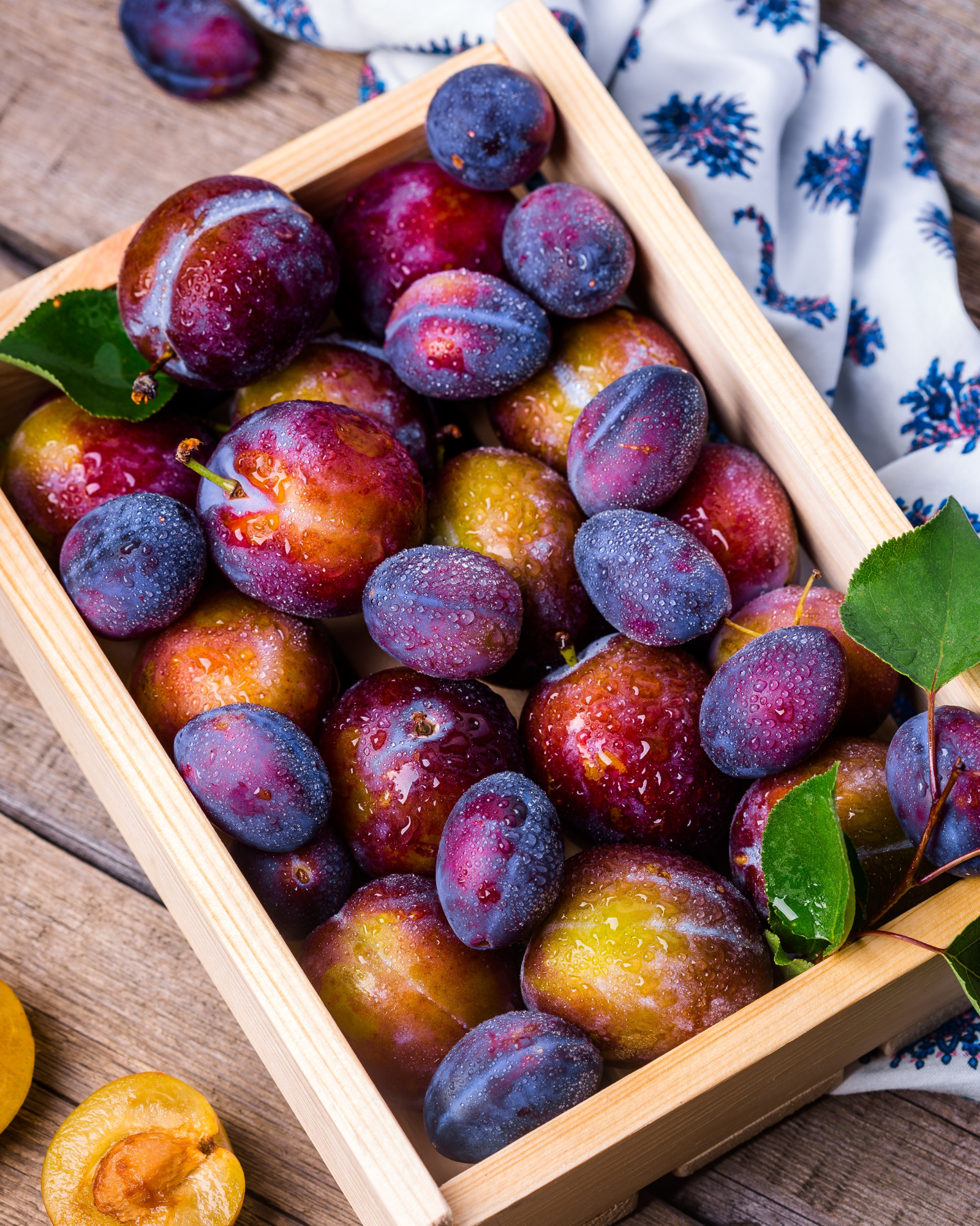 A box of freshly picked plum. Sea Salt + Plum fragrance oil for soap and candlemaking.